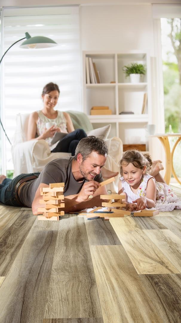 a family playing on black bird teak flooring