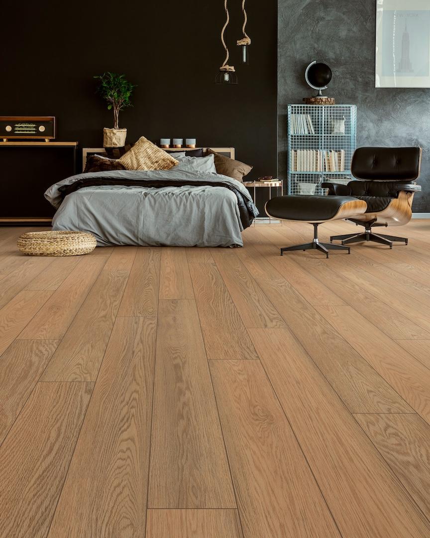 A bedroom furnished with pea patch oak flooring